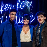 President Mantella takes a photo with two boys in jackets.
